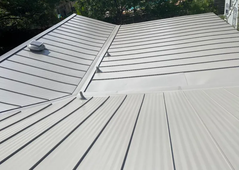 Solar attic fan installed on a metal roof for Roof Ventilation in Auburn